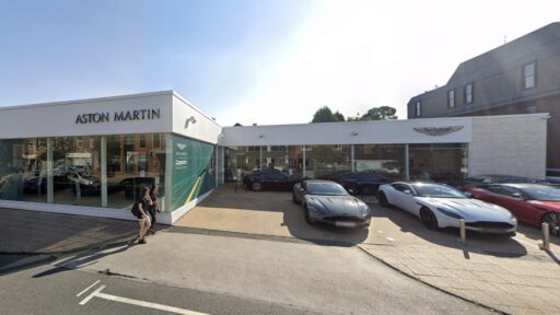 Police are investigating after a Volkswagen Tiguan lost control and ended up on top of a £200,000 Aston Martin DBS outside Aston Martin Manchester in Wilmslow. The incident caused significant damage but no injuries.