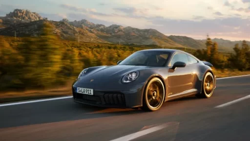Porsche breaks a 60-year tradition by removing iconic features from the new 911. The hybrid model will have a digital rev counter and start/stop button, sparking mixed fan reactions.