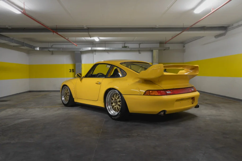 A 1996 Porsche 911 GT2 with just 30 miles on the odometer is set to be auctioned for £1.4 million. This vibrant Speed Yellow, 480 bhp car is a rare collector's gem.