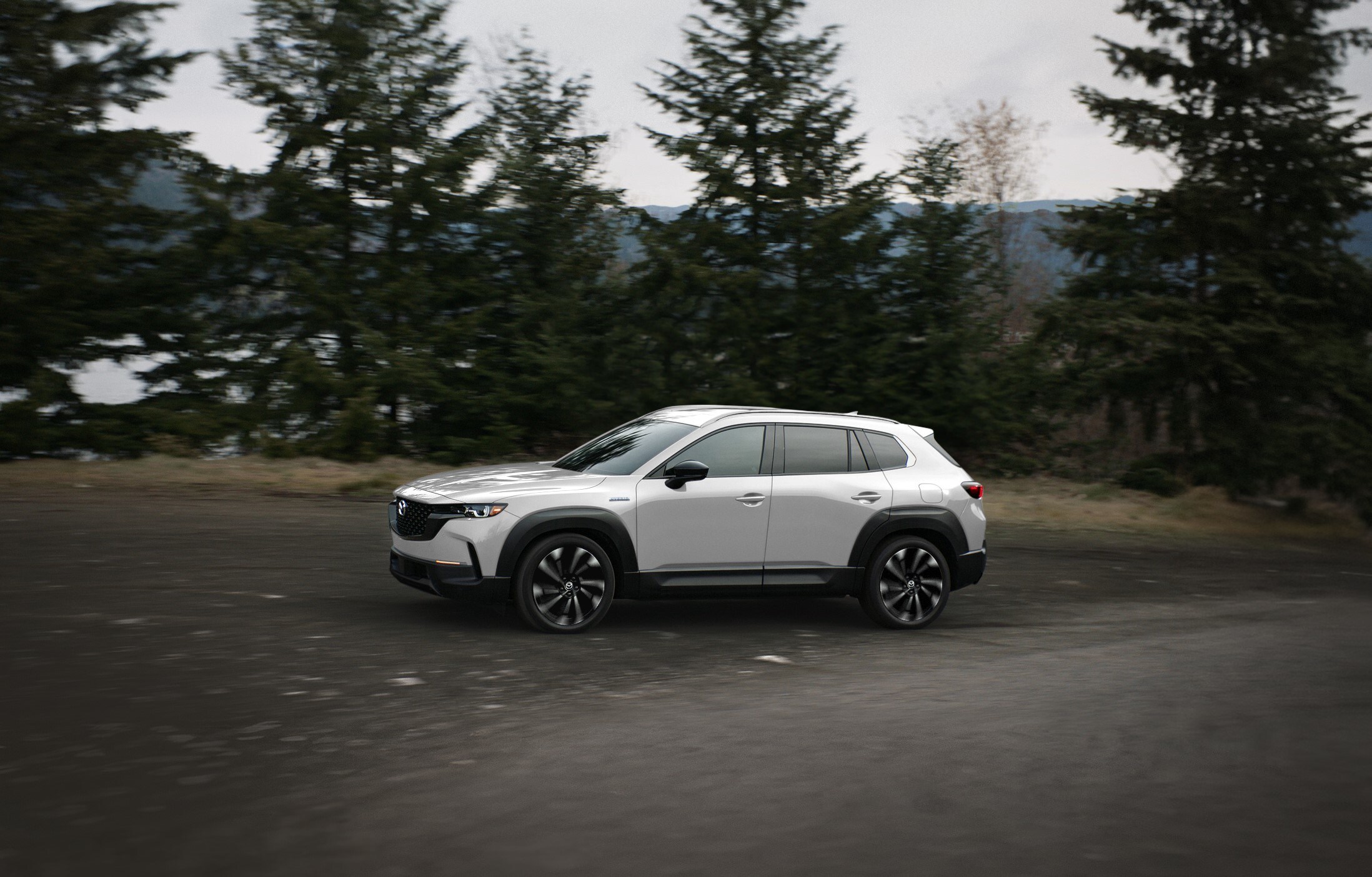 Mazda unveils the 2025 CX-50, introducing a hybrid model with 38 mpg and versatile features for active lifestyles. Pricing starts at $30,300, with advanced safety and driving technologies.