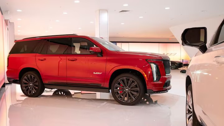 Cadillac unveils the refreshed 2025 Escalade, blending classic V-8 power with new tech and design updates inspired by its electric counterpart, the Escalade IQ.