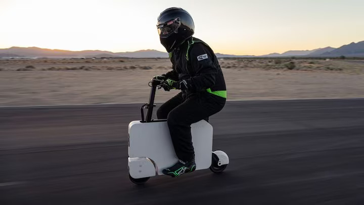 Honda's Motocompacto electric folding moped, MotorTrend's official pit bike for the 2024 Performance Vehicle of the Year event, simplifies racetrack logistics with its lightweight, foldable design and 12-mile range.