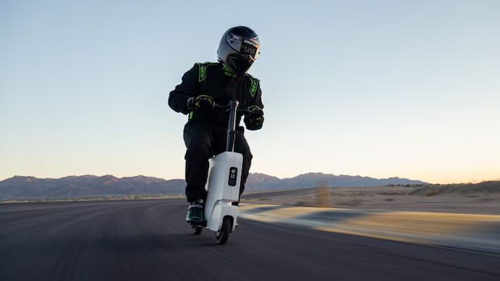 Honda's Motocompacto electric folding moped, MotorTrend's official pit bike for the 2024 Performance Vehicle of the Year event, simplifies racetrack logistics with its lightweight, foldable design and 12-mile range.