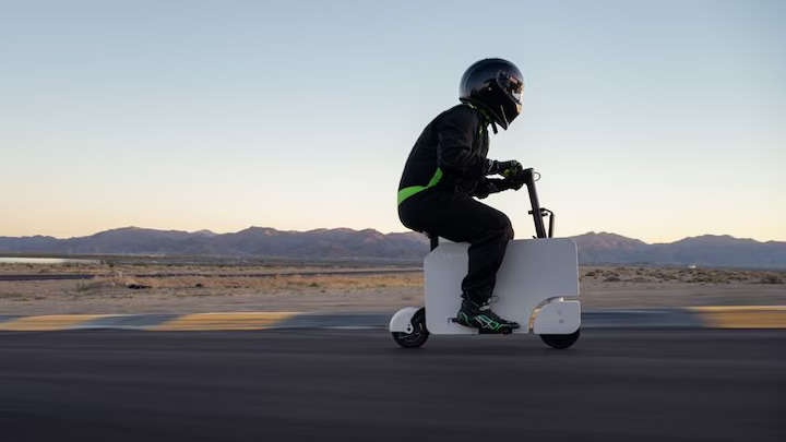 Honda's Motocompacto electric folding moped, MotorTrend's official pit bike for the 2024 Performance Vehicle of the Year event, simplifies racetrack logistics with its lightweight, foldable design and 12-mile range.