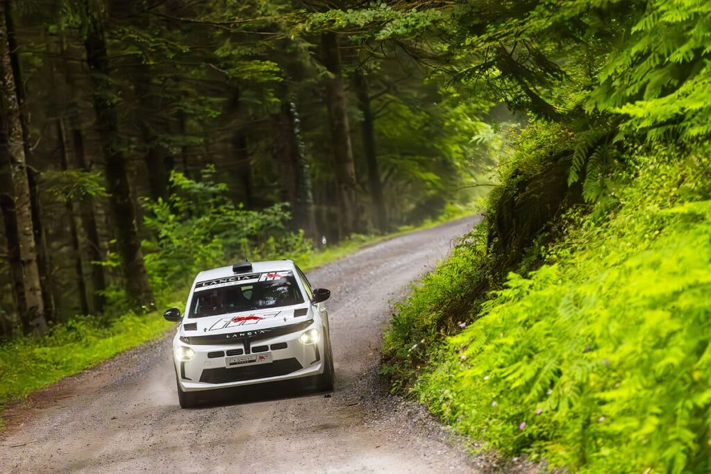 Lancia returns to rally racing with Miki Biasion test-driving the Ypsilon Rally 4 HF, marking a new era with a 212 hp engine and advanced performance tuning for competitive racing.