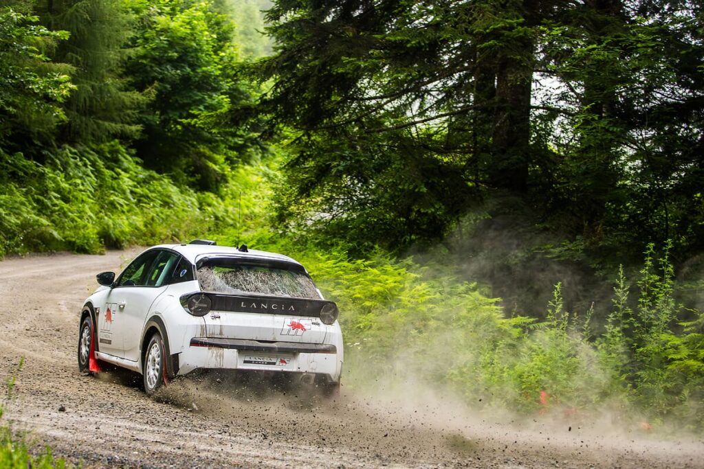 Lancia returns to rally racing with Miki Biasion test-driving the Ypsilon Rally 4 HF, marking a new era with a 212 hp engine and advanced performance tuning for competitive racing.