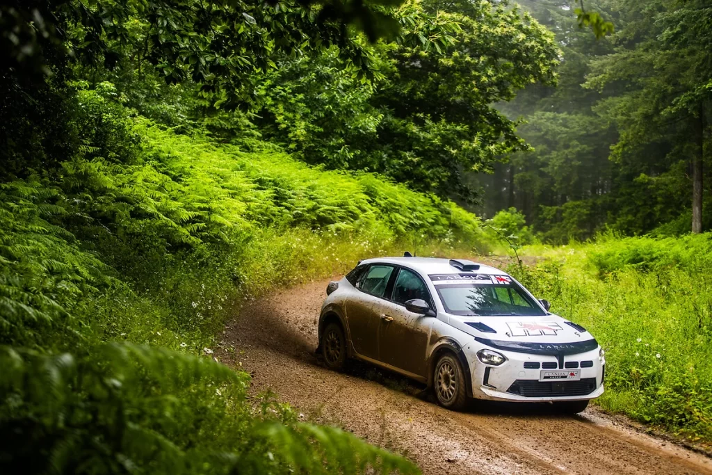 Lancia returns to rally racing with Miki Biasion test-driving the Ypsilon Rally 4 HF, marking a new era with a 212 hp engine and advanced performance tuning for competitive racing.