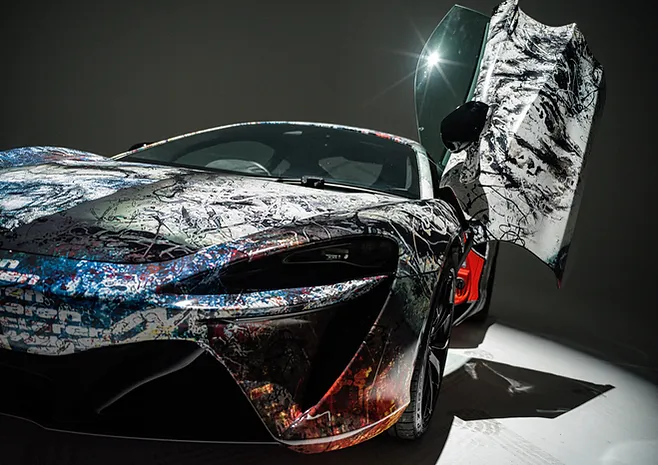 The "ROARING INTO THE FUTURE" exhibition at McLaren Showroom in Kuala Lumpur showcased a collaboration between McLaren, Jaee Tee, and Mitsuhiro Higuchi, celebrating the Tiger's courage and McLaren's legacy.