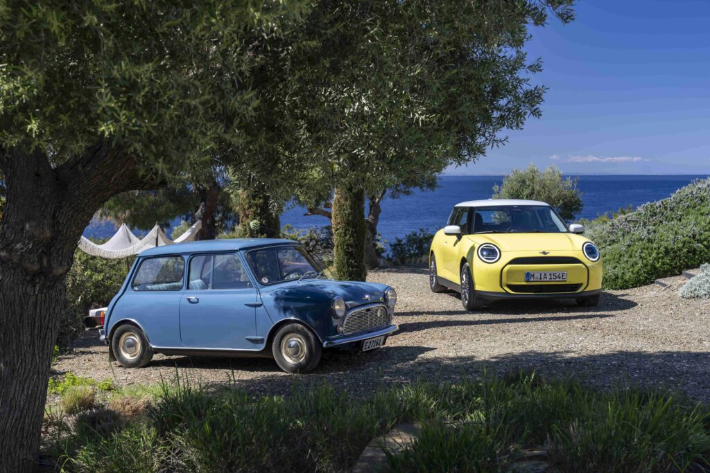 The all-electric MINI Cooper E in Sunny Side Yellow features white roof and mirror caps, 17″ U-Spoke rims, and a sporty interior, perfectly matching Greece's Mediterranean charm.