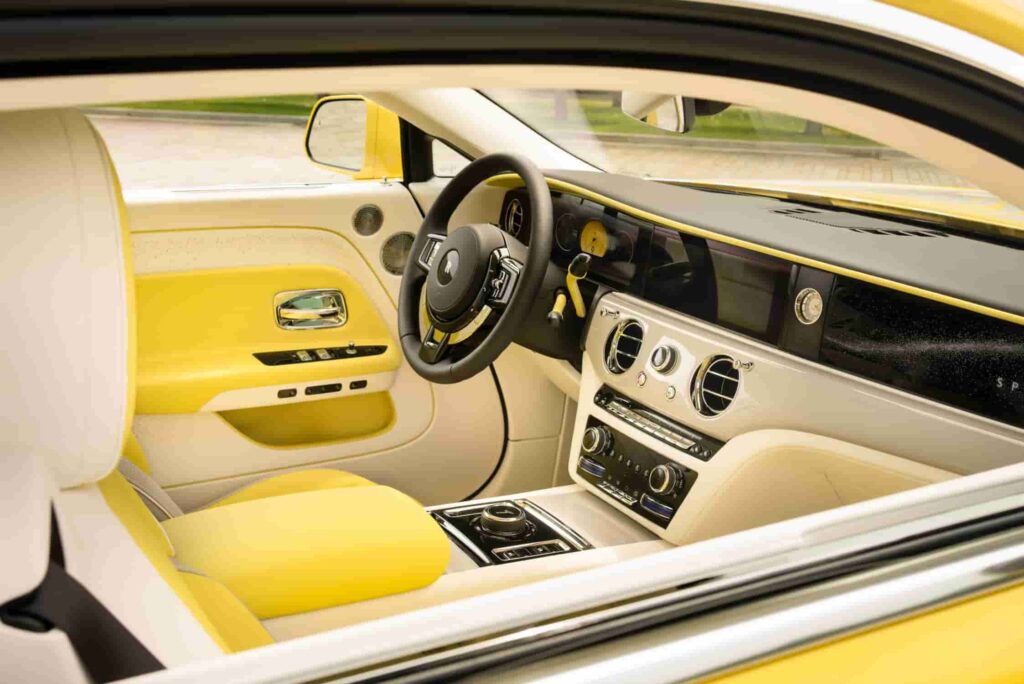 Rolls-Royce debuts the Spectre Semaphore, a bespoke one-off creation in vibrant Semaphore Yellow, at Monterey Car Week 2024, featuring luxurious custom interiors and unique design elements.