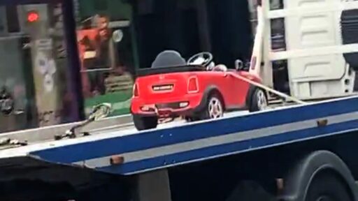 A toy Mini Cooper was hilariously towed on Kensington High Street, leaving locals joking about the kid's "illegal parking" and Hollywood actor Warwick Davis.