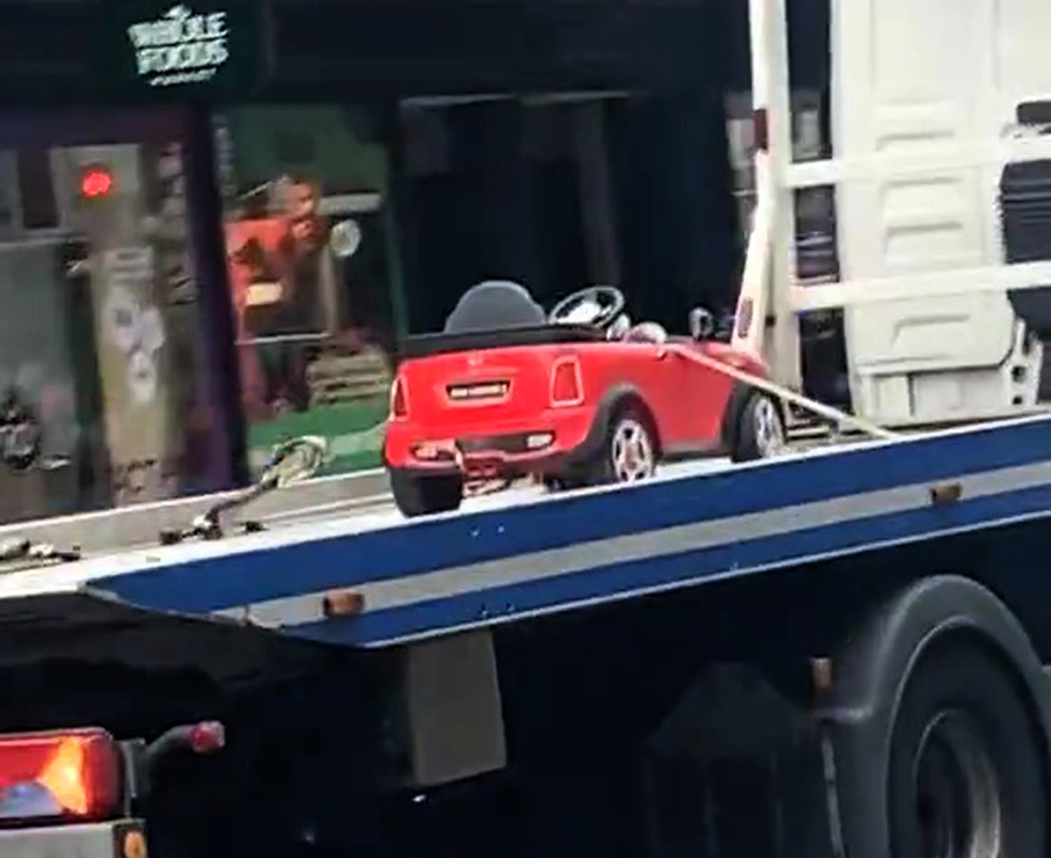 A toy Mini Cooper was hilariously towed on Kensington High Street, leaving locals joking about the kid's "illegal parking" and Hollywood actor Warwick Davis.