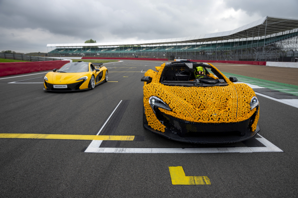 Lando Norris tests a life-size LEGO Technic McLaren P1 at Silverstone Circuit, the first LEGO model capable of completing a lap, showcasing the creativity and engineering prowess of LEGO and McLaren.