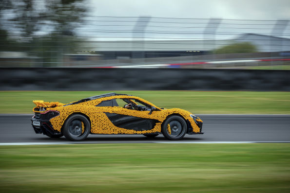 Lando Norris tests a life-size LEGO Technic McLaren P1 at Silverstone Circuit, the first LEGO model capable of completing a lap, showcasing the creativity and engineering prowess of LEGO and McLaren.