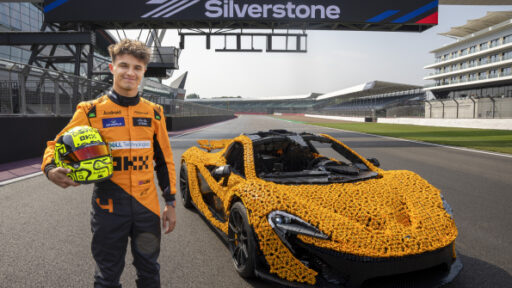 Lando Norris tests a life-size LEGO Technic McLaren P1 at Silverstone Circuit, the first LEGO model capable of completing a lap, showcasing the creativity and engineering prowess of LEGO and McLaren.