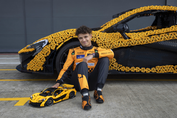 Lando Norris tests a life-size LEGO Technic McLaren P1 at Silverstone Circuit, the first LEGO model capable of completing a lap, showcasing the creativity and engineering prowess of LEGO and McLaren.