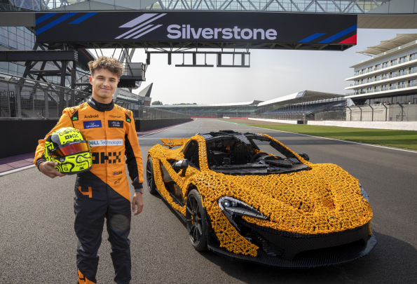 Lando Norris tests a life-size LEGO Technic McLaren P1 at Silverstone Circuit, the first LEGO model capable of completing a lap, showcasing the creativity and engineering prowess of LEGO and McLaren.