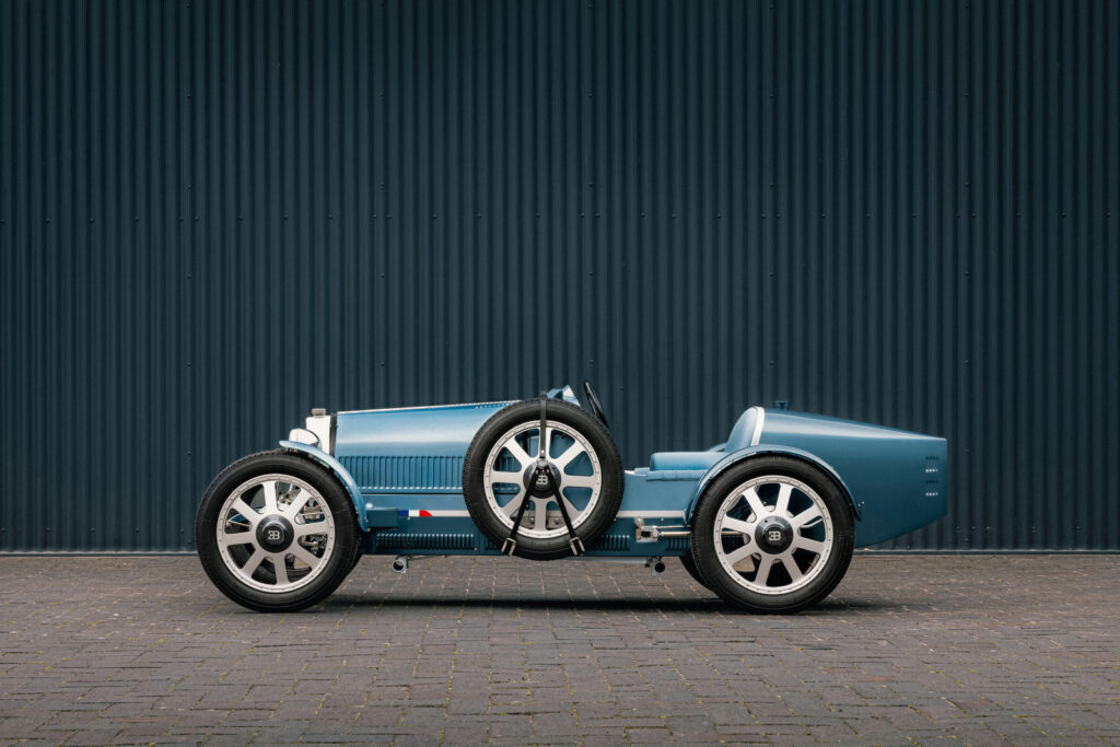 The Bugatti Baby II Tourbillon Edition, hand-built by Hedley Studios, fuses Bugatti's rich racing heritage with modern design, showcasing exquisite craftsmanship and luxury detailing.