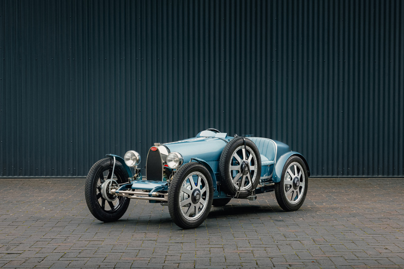 The Bugatti Baby II Tourbillon Edition, hand-built by Hedley Studios, fuses Bugatti's rich racing heritage with modern design, showcasing exquisite craftsmanship and luxury detailing.