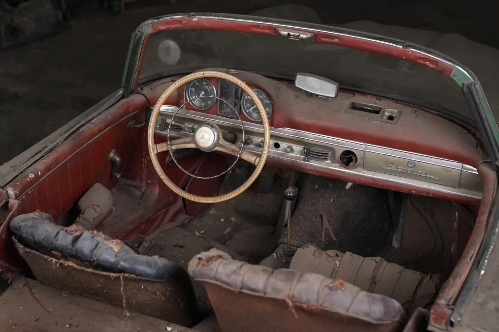 A rare 1957 Mercedes-Benz 300 SL Roadster, in need of restoration, is set to sell for £750,000 due to its exclusivity, despite looking like it belongs in a scrapyard.