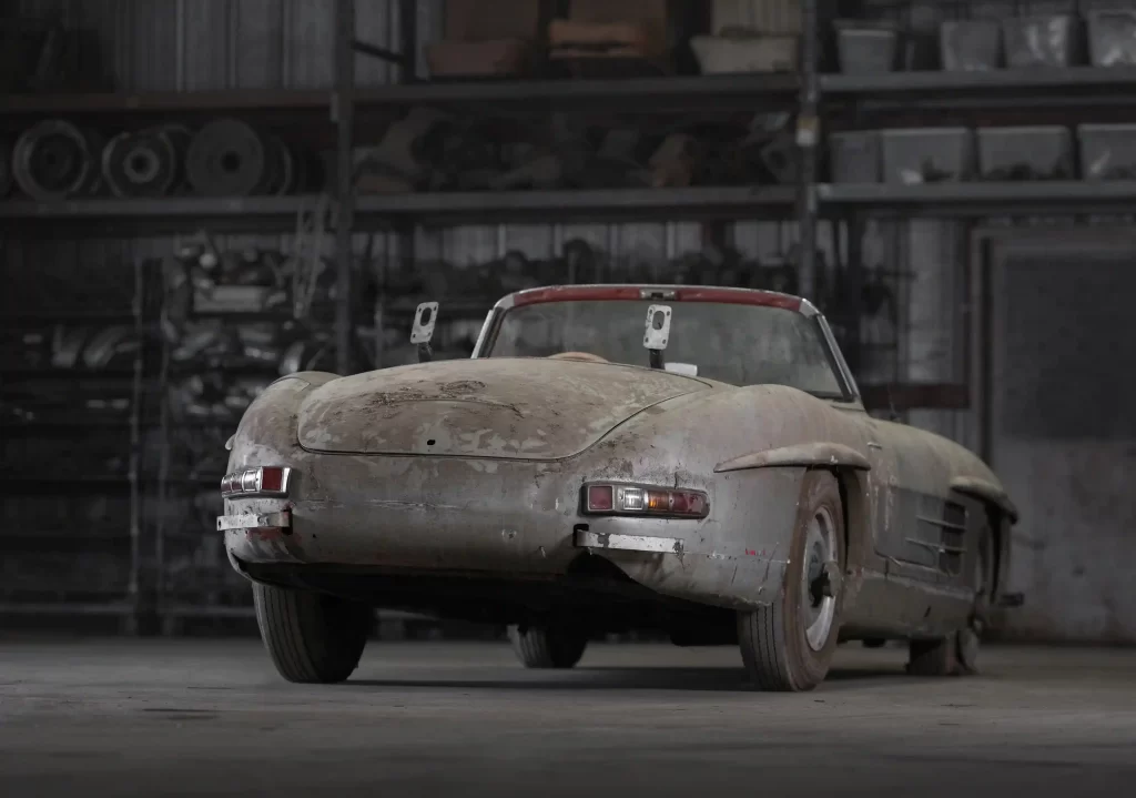 A rare 1957 Mercedes-Benz 300 SL Roadster, in need of restoration, is set to sell for £750,000 due to its exclusivity, despite looking like it belongs in a scrapyard.