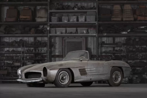 A rare 1957 Mercedes-Benz 300 SL Roadster, in need of restoration, is set to sell for £750,000 due to its exclusivity, despite looking like it belongs in a scrapyard.