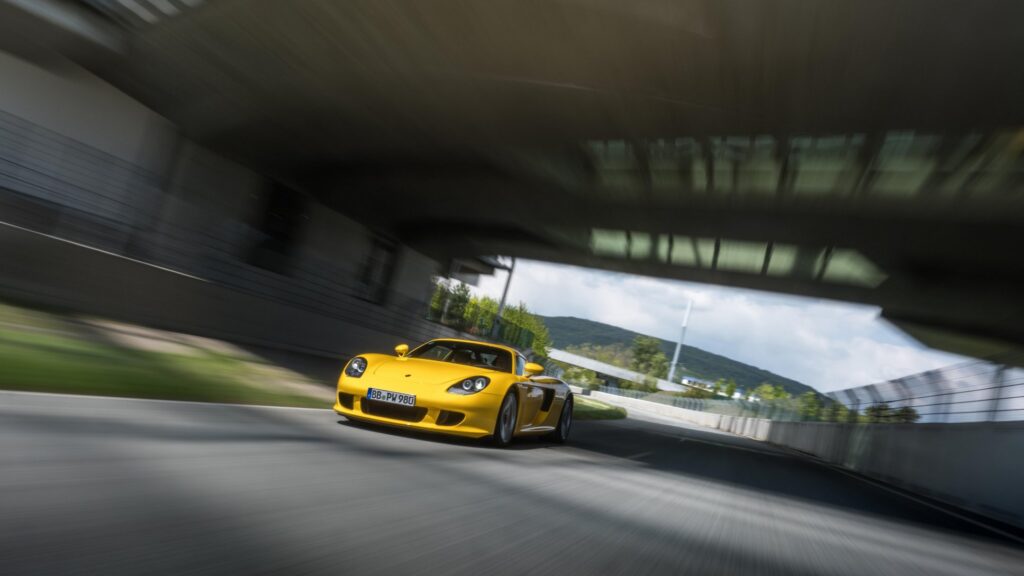 Porsche teams up with Michelin to develop new ultra-high-performance tyres for the Carrera GT, enhancing its handling, safety, and performance on both wet and dry surfaces.