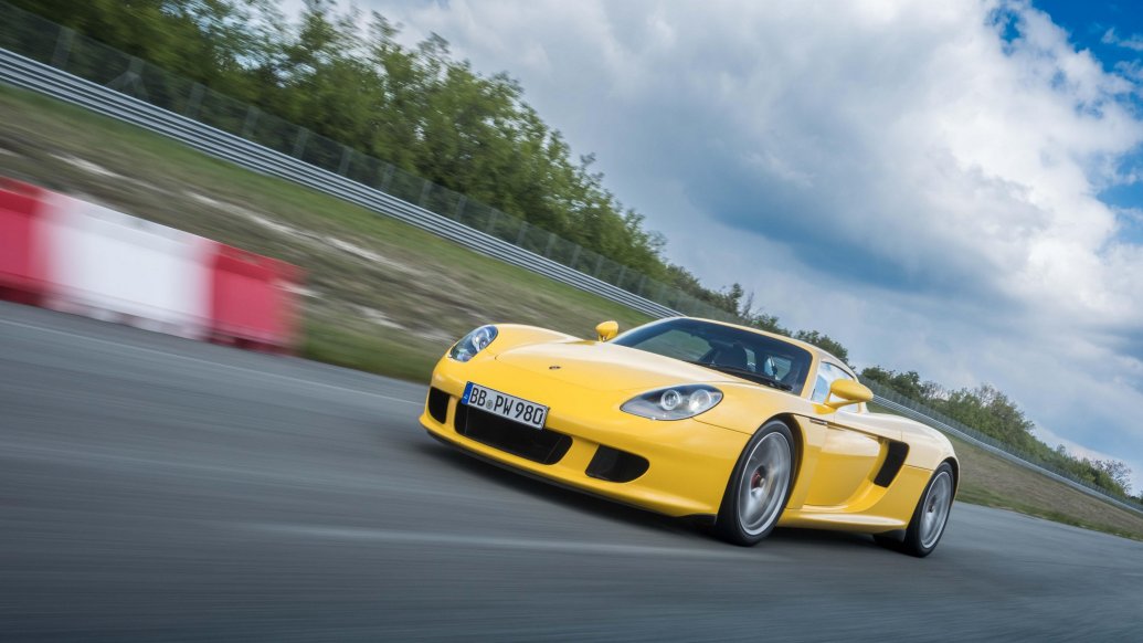 Porsche teams up with Michelin to develop new ultra-high-performance tyres for the Carrera GT, enhancing its handling, safety, and performance on both wet and dry surfaces.