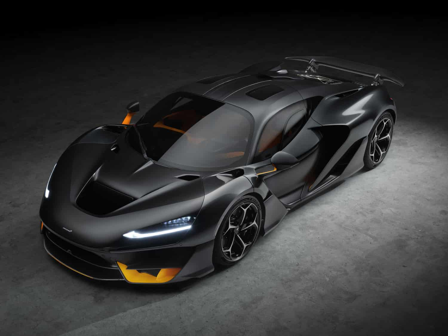 The McLaren W1 debuts as the most powerful McLaren ever, boasting a V8 hybrid powertrain with 1,275 PS, advanced aerodynamics, and a top speed of 350 km/h. Limited to 399 units.