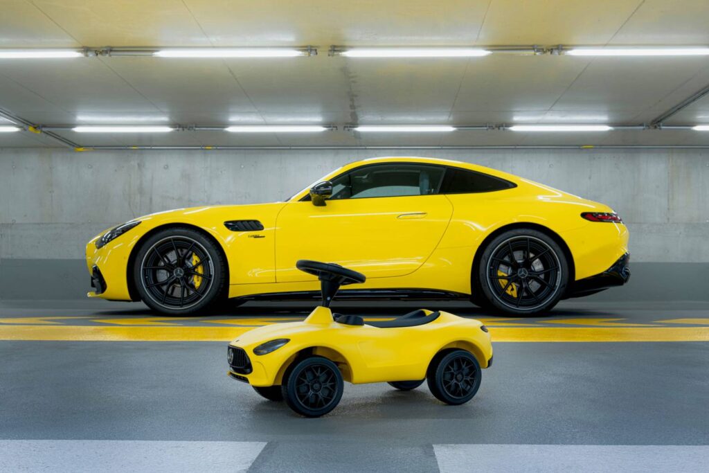 Mercedes-Benz introduces the 7th generation Bobby-AMG GT ride-on car for kids, featuring enhanced ergonomics, realistic design, and available in hyper blue with LED lights or sun yellow.