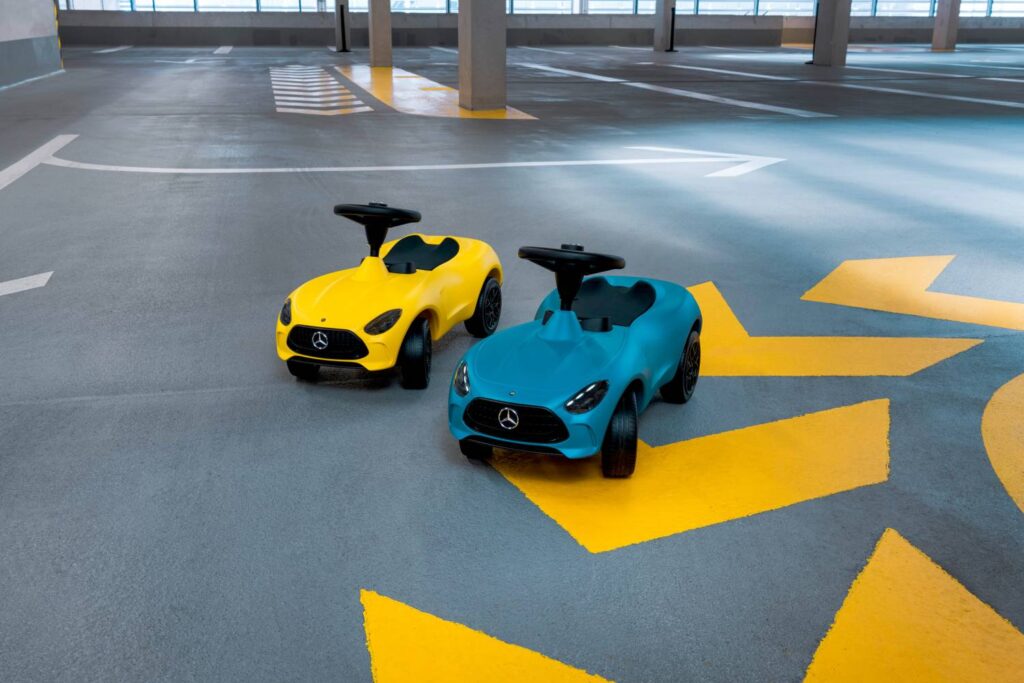 Mercedes-Benz introduces the 7th generation Bobby-AMG GT ride-on car for kids, featuring enhanced ergonomics, realistic design, and available in hyper blue with LED lights or sun yellow.