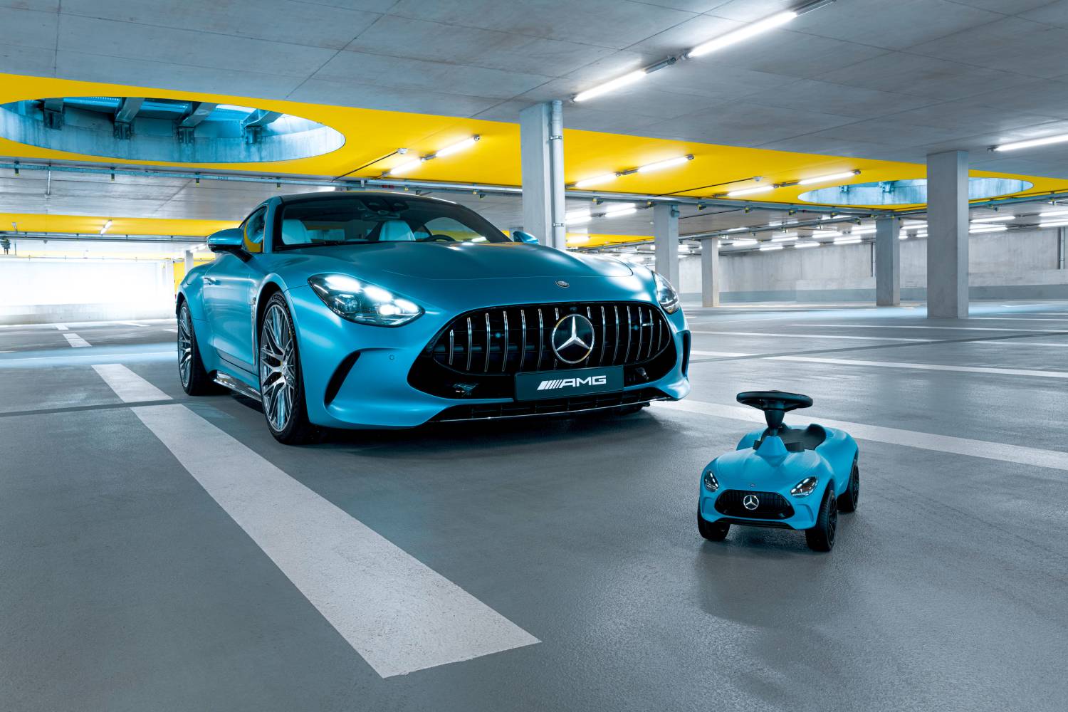 Mercedes-Benz introduces the 7th generation Bobby-AMG GT ride-on car for kids, featuring enhanced ergonomics, realistic design, and available in hyper blue with LED lights or sun yellow.