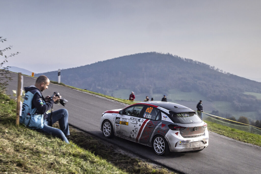 Belgian driver Tom Heindrichs wins the ADAC Opel Electric Rally Cup finale in Lower Bavaria, while Anthony Rott secures second place overall despite a late setback in the Power Stage.