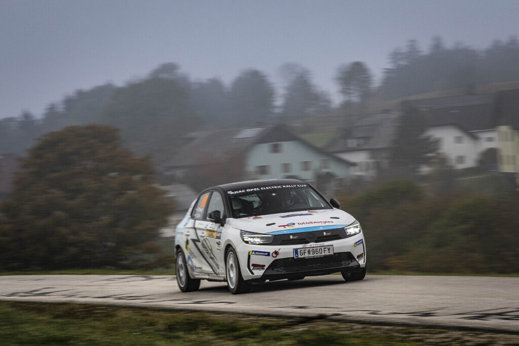 Belgian driver Tom Heindrichs wins the ADAC Opel Electric Rally Cup finale in Lower Bavaria, while Anthony Rott secures second place overall despite a late setback in the Power Stage.