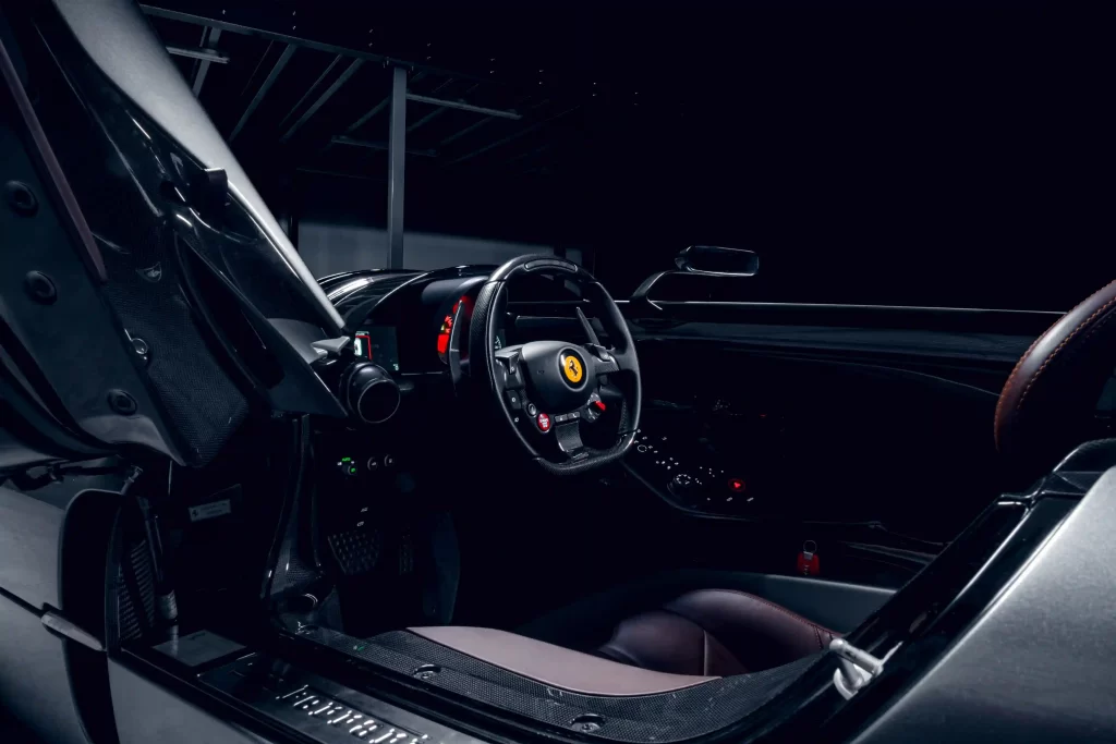 Rare 2022 Ferrari Monza SP1 with a V-12 engine and only 1,182 miles, set to sell for £2.91m at auction. The one-seater, open-top design makes it a collector's dream.