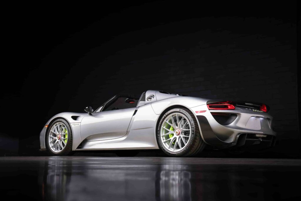 An ultra-rare 2015 Porsche 918 Weissach Spyder with only 170 miles is set to sell for £2.7 million. This limited-edition hybrid hypercar offers 887 horsepower and high-end racing features.