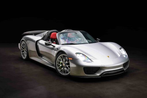 An ultra-rare 2015 Porsche 918 Weissach Spyder with only 170 miles is set to sell for £2.7 million. This limited-edition hybrid hypercar offers 887 horsepower and high-end racing features.