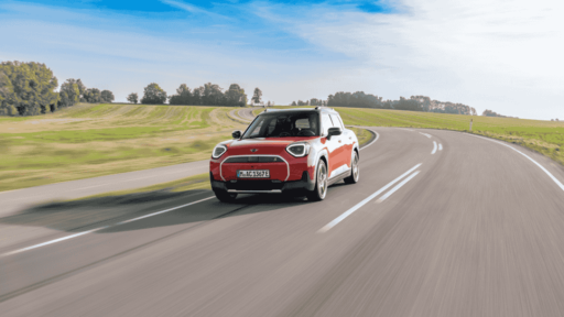 Discover the MINI Aceman SE in Rebel Red, blending Scandinavian-inspired design, a panoramic glass roof, and advanced OLED technology for a stylish, modern driving experience.