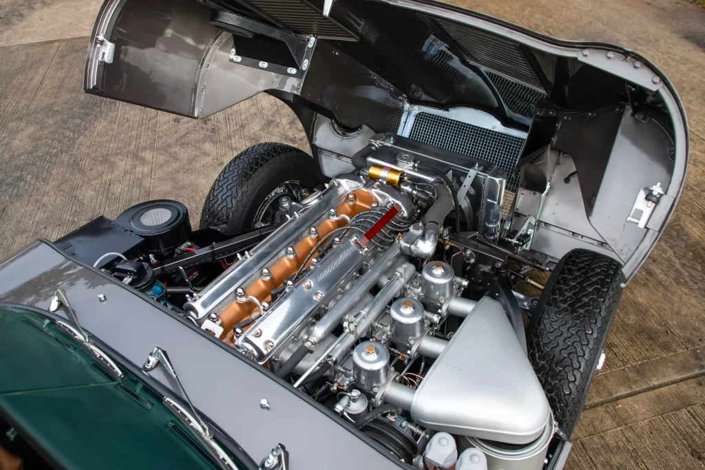 Classic Jaguar E-type Roadster transformed after 3,500-hour restoration, quadrupling value to £200k. Sleek silver body, modern upgrades, dubbed 'prettiest car.'