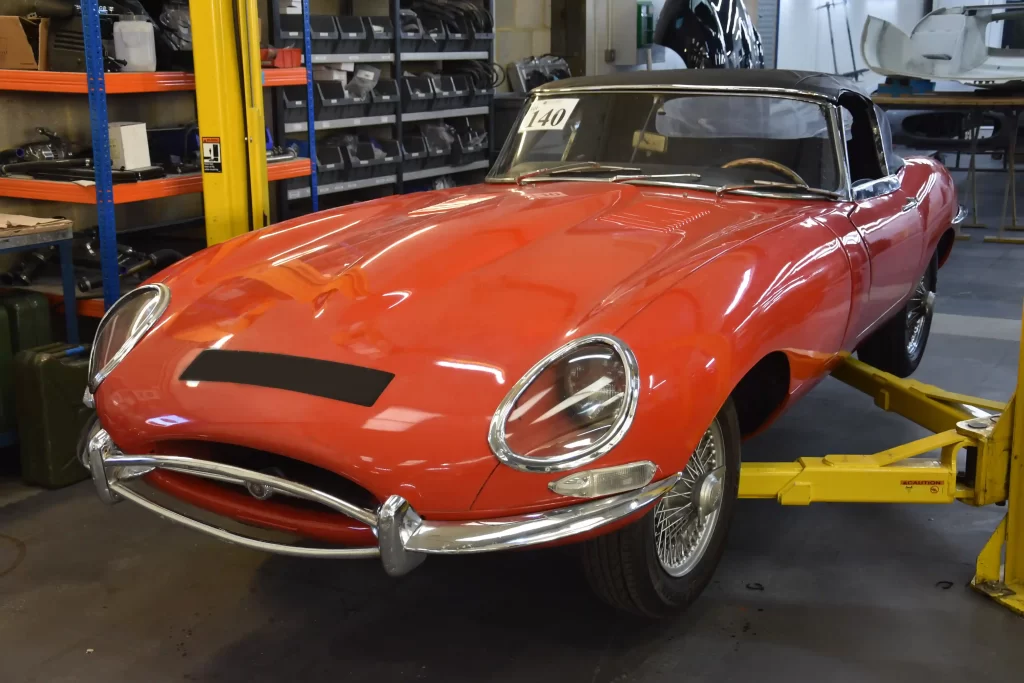 Classic Jaguar E-type Roadster transformed after 3,500-hour restoration, quadrupling value to £200k. Sleek silver body, modern upgrades, dubbed 'prettiest car.'