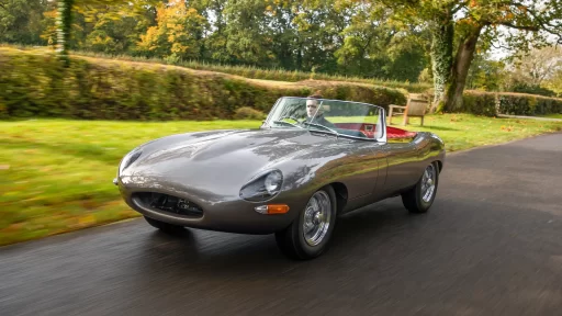 Classic Jaguar E-type Roadster transformed after 3,500-hour restoration, quadrupling value to £200k. Sleek silver body, modern upgrades, dubbed 'prettiest car.'