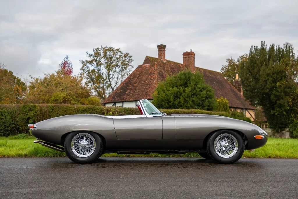 Classic Jaguar E-type Roadster transformed after 3,500-hour restoration, quadrupling value to £200k. Sleek silver body, modern upgrades, dubbed 'prettiest car.'