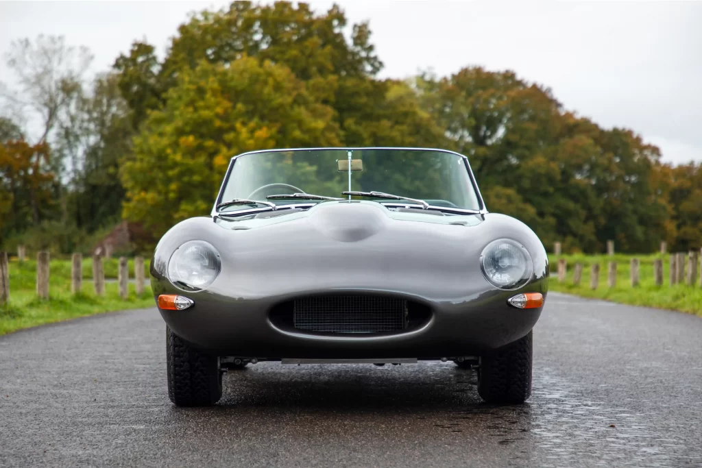 Classic Jaguar E-type Roadster transformed after 3,500-hour restoration, quadrupling value to £200k. Sleek silver body, modern upgrades, dubbed 'prettiest car.'