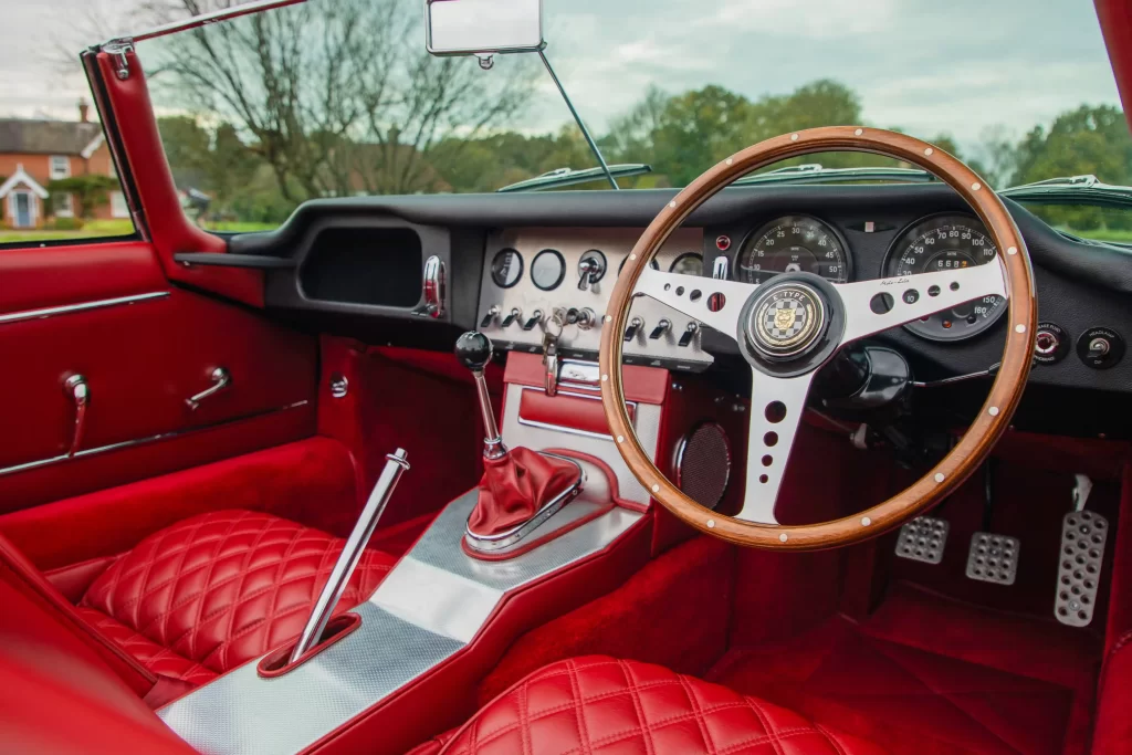 Classic Jaguar E-type Roadster transformed after 3,500-hour restoration, quadrupling value to £200k. Sleek silver body, modern upgrades, dubbed 'prettiest car.'