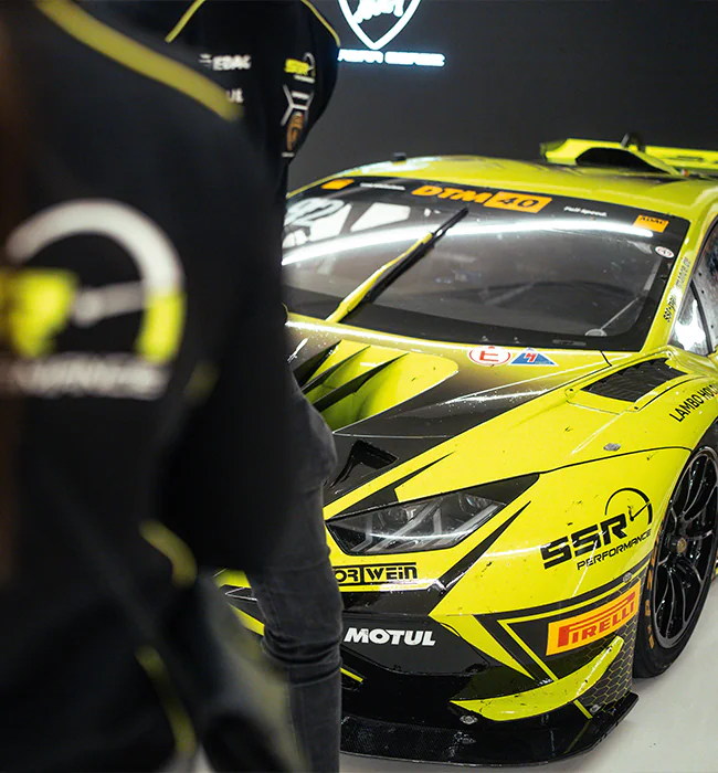 Lamborghini honors Mirko Bortolotti at its museum in Sant'Agata Bolognese, showcasing his DTM championship-winning Huracán GT3 EVO2 alongside other iconic racing models.