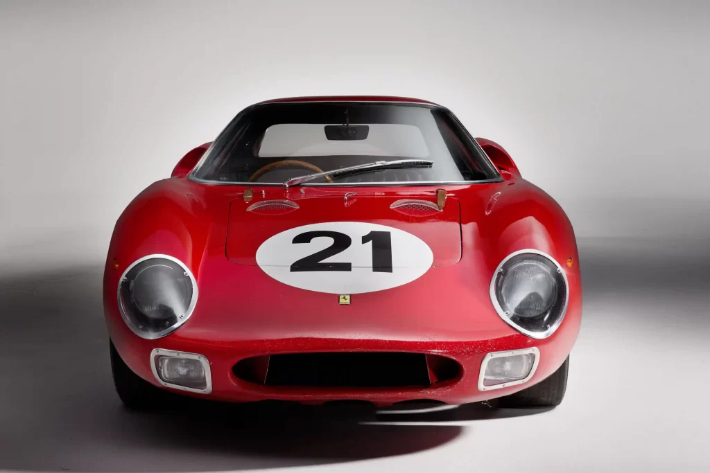 A legendary Ferrari 250 LM by Scaglietti, with a winning history at Le Mans, is up for auction at £20M. Despite scuffs and a ripped seat, it’s a collector’s dream.