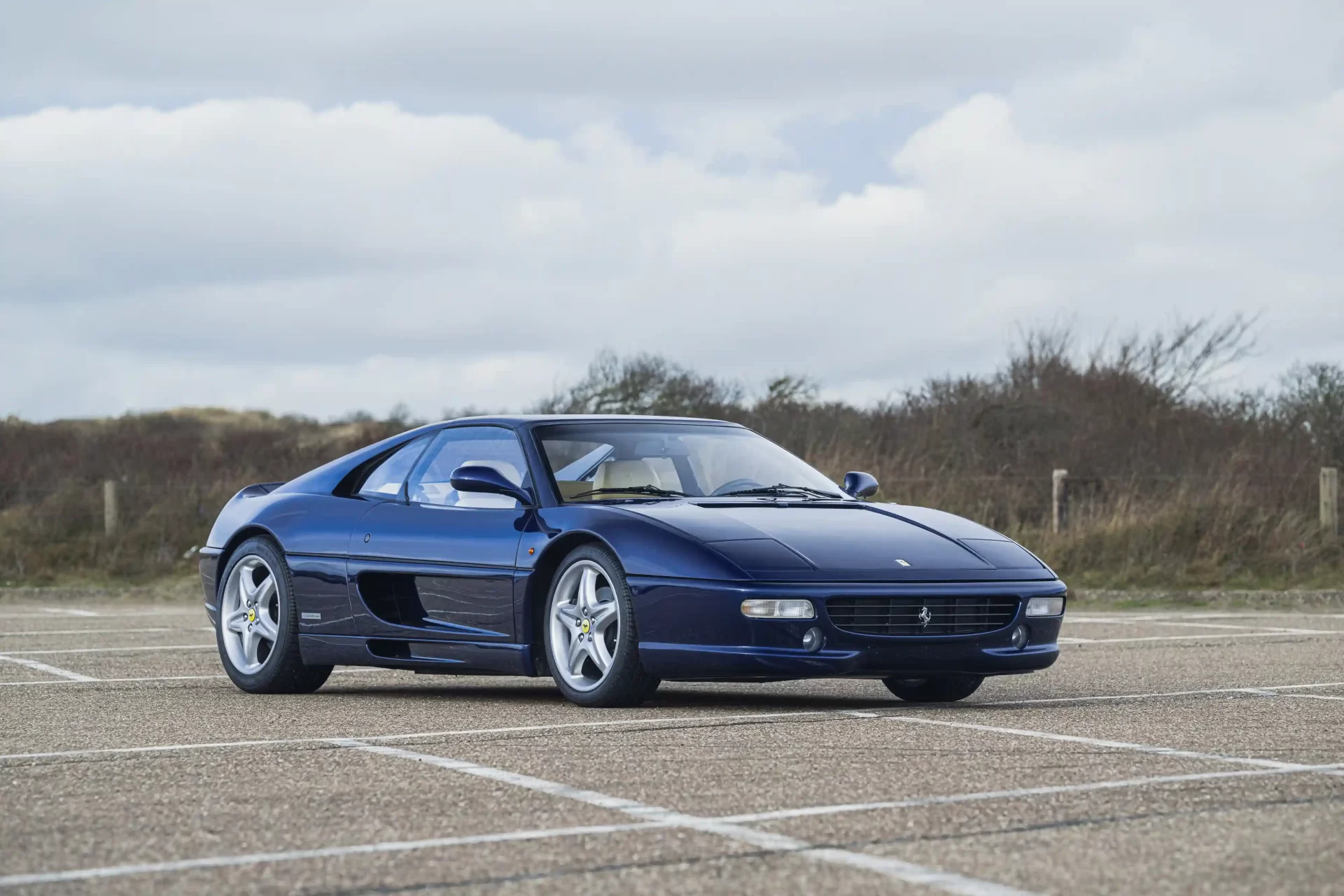 Michael Schumacher's first Ferrari, a rare 1996 F355 GTS, is set for auction. Signed by the legend and customized to his specs, this iconic car is expected to fetch a record price.