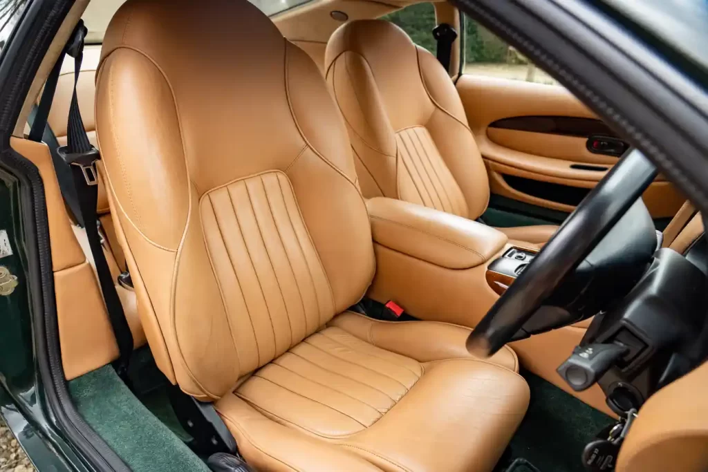 A 1995 Aston Martin DB7 once owned by Sir Elton John sold for £39,375 at auction, exceeding expectations. The low-mileage classic boasts custom features and celebrity history.