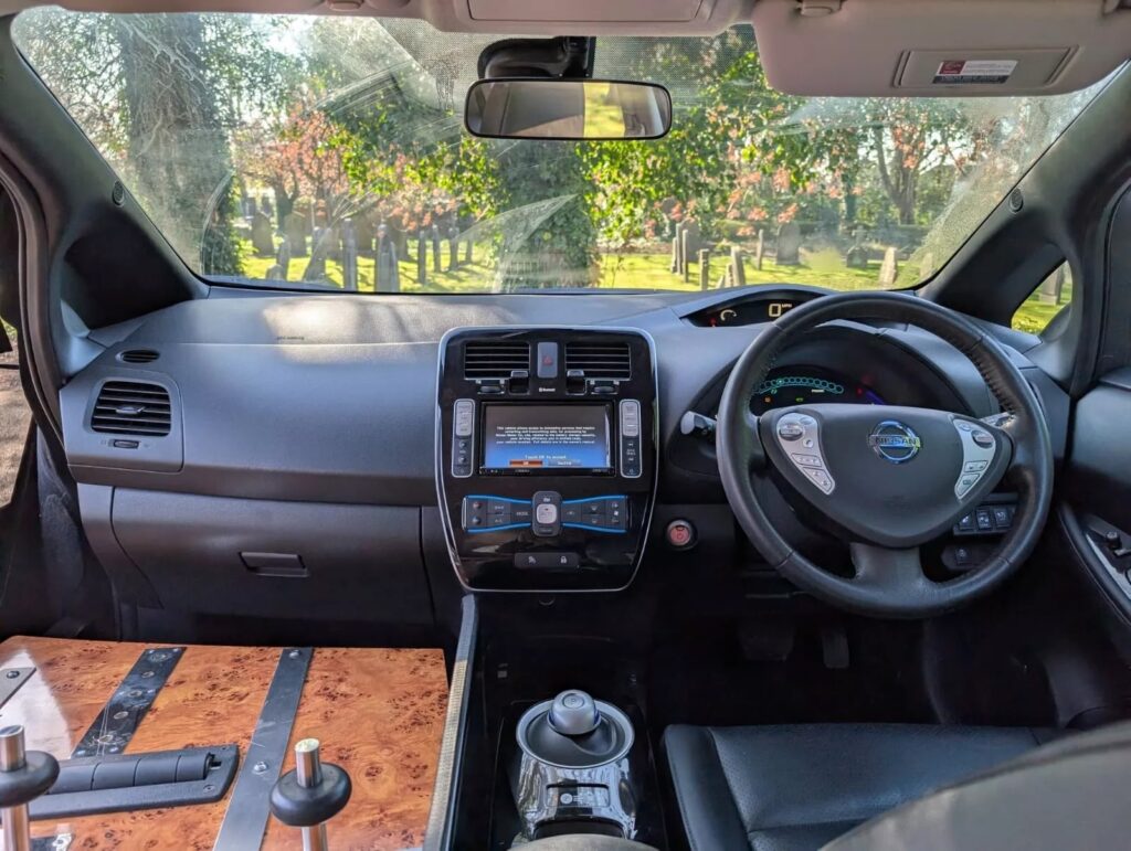 Custom eco-hearse built from Nissan Leaf hits market for £12,500 - converted electric car holds a full casket, travels 100 miles per charge and offers quiet, green funerals.