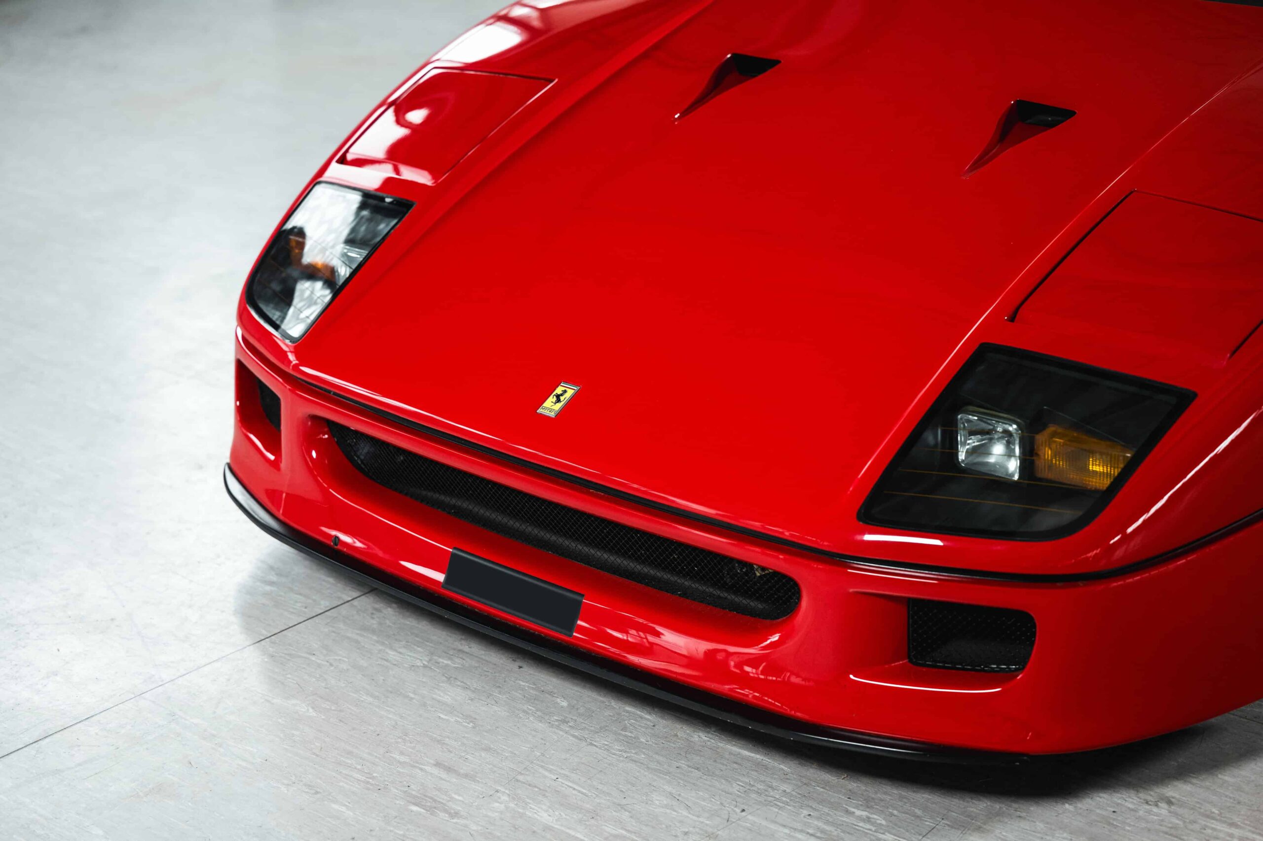 A rare 1989 Ferrari F40 with only 10,749 miles is set to sell for £2.3m at RM Sotheby’s Milan auction, potentially breaking the record for this iconic supercar.